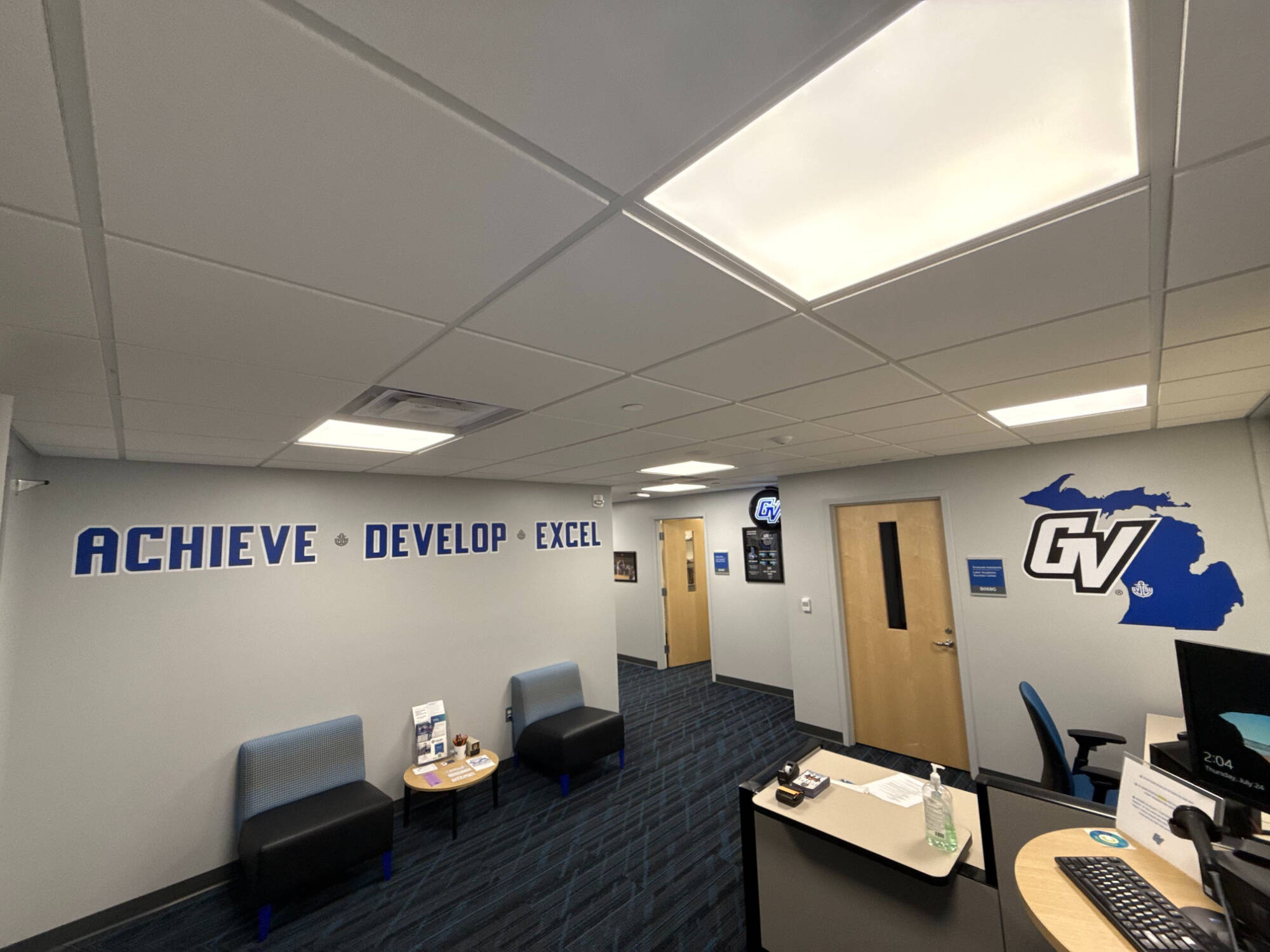 inside view of the laker academic success center lobby with chairs and a table on the left and the welcome desk on the right